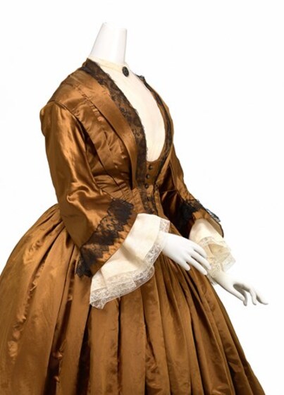 Golden dress on a mannequin seen from side