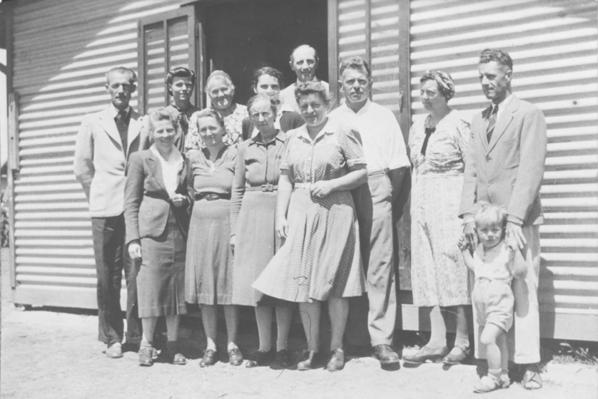Group of men and women in front of building