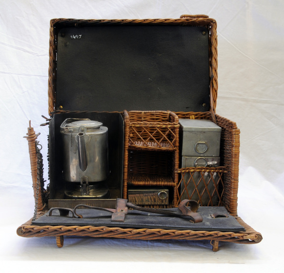 Basket containing tea kettle, other containers and utensils