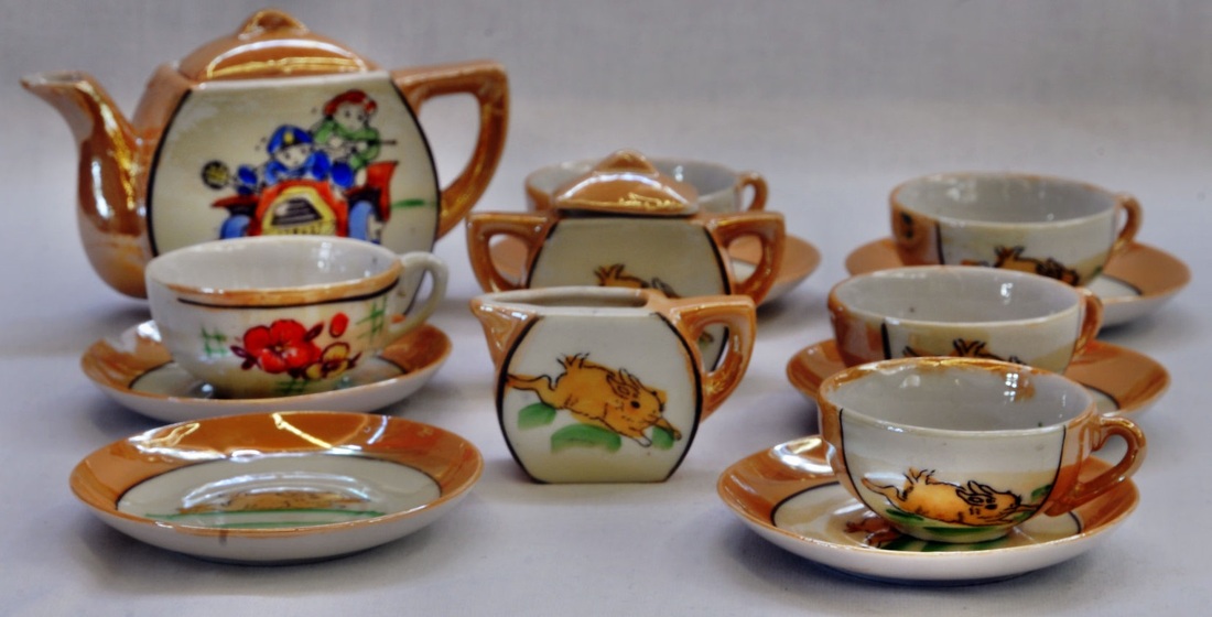 Tea kettle with tea cups and saucers