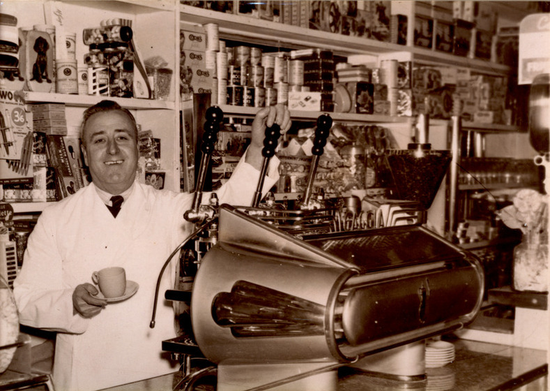 Man standing behind espresso machine