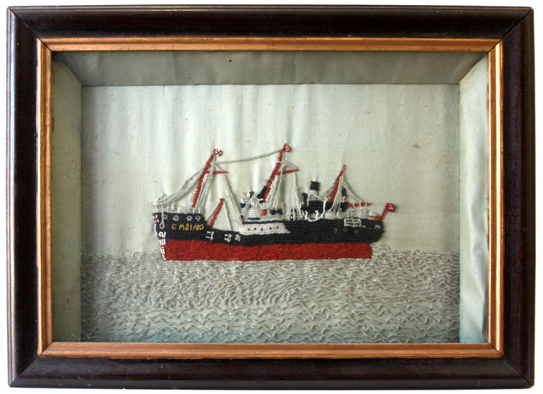Embroidered ship on water in frame