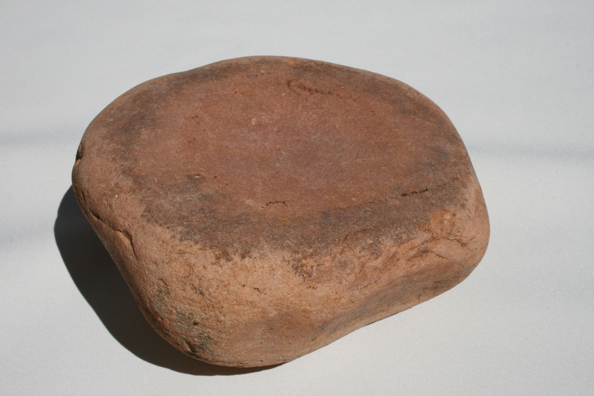 Reddish brown grinding stone 