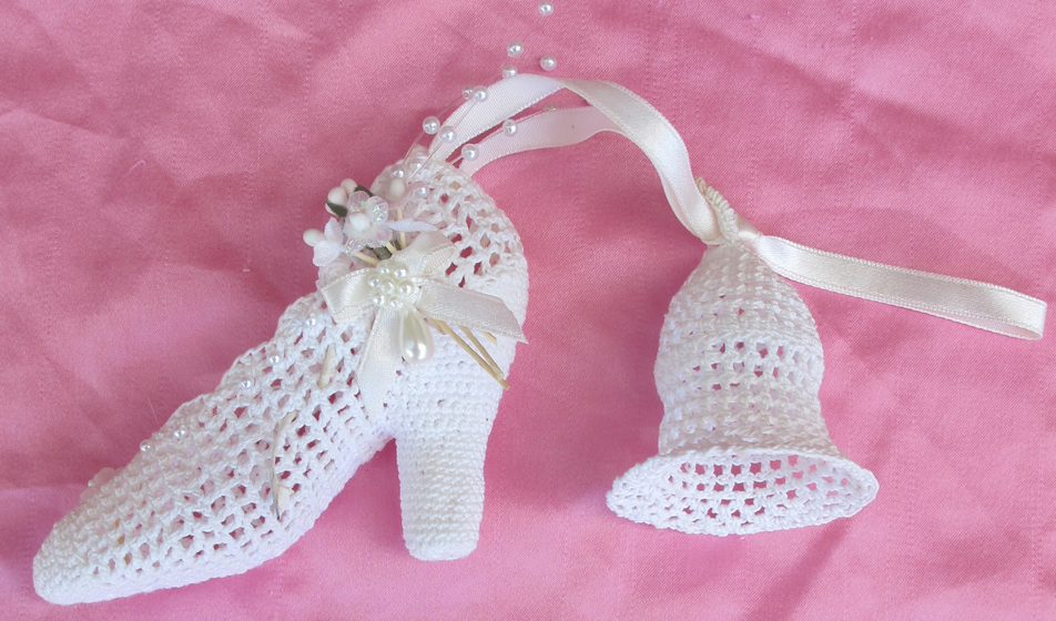 Crocheted white shoe with crocheted bell
