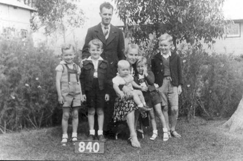 Man woman and five children in garden