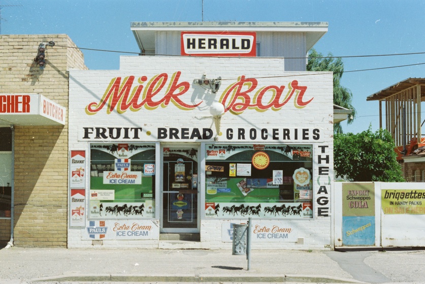 White building with "Milk Bar" in orange lettering