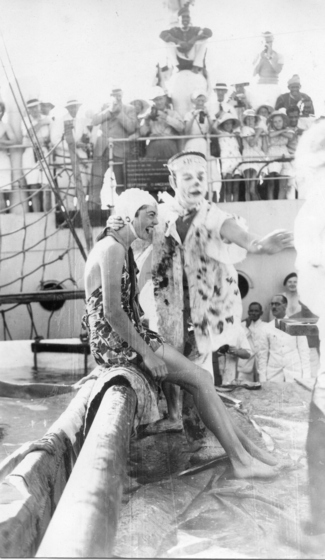 a man in fancy-dress  about to dunk a women in bathers