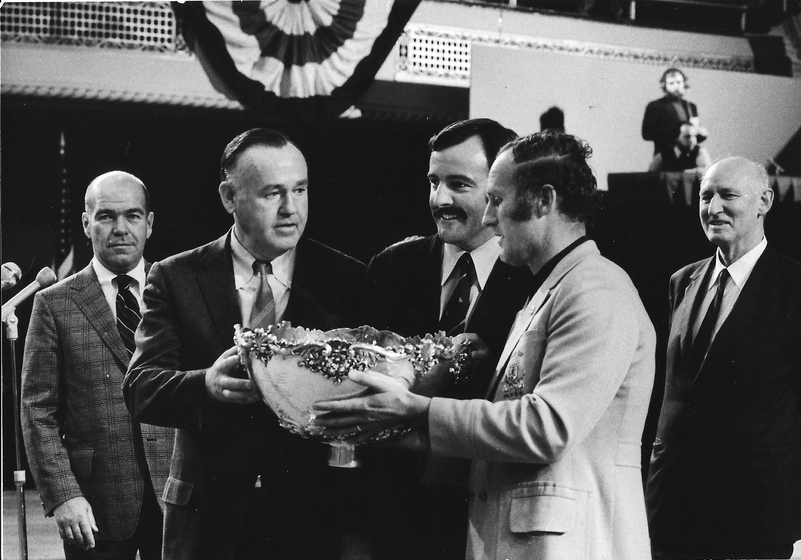 a man being handed an award by officals