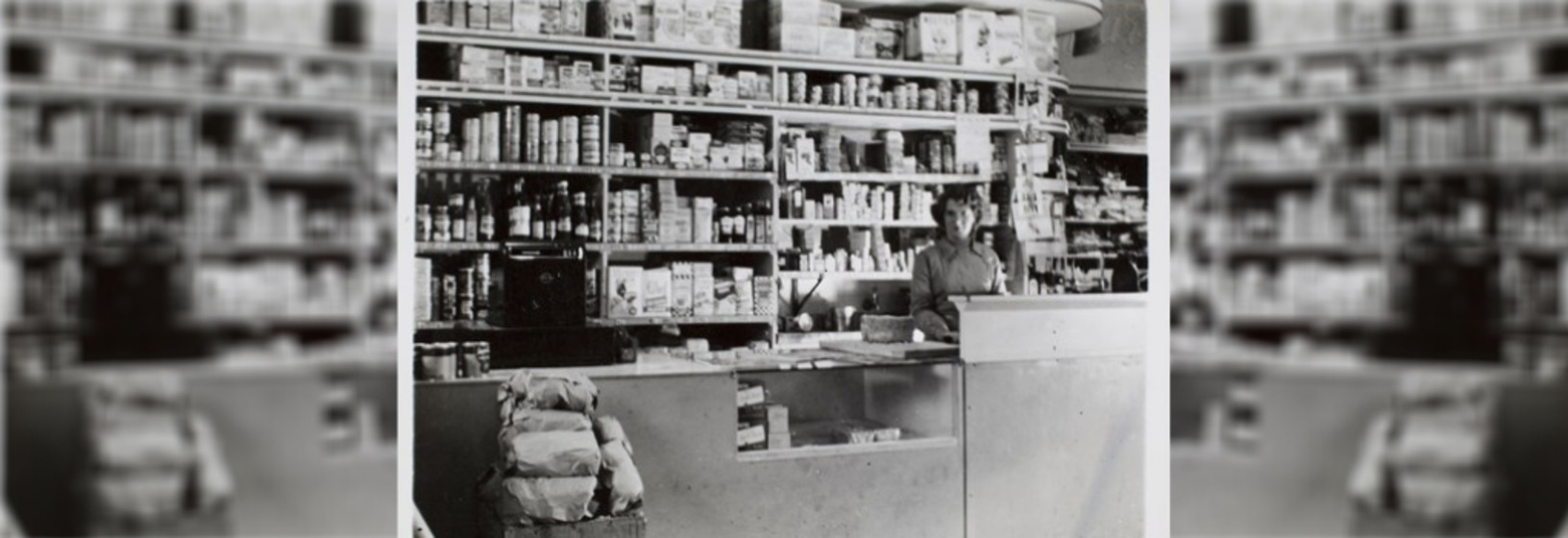 Woman standing in front of shelving in a general store