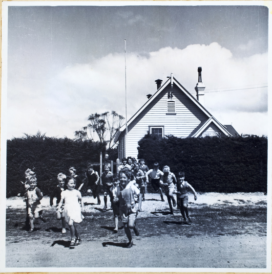 Young children happily running out of building