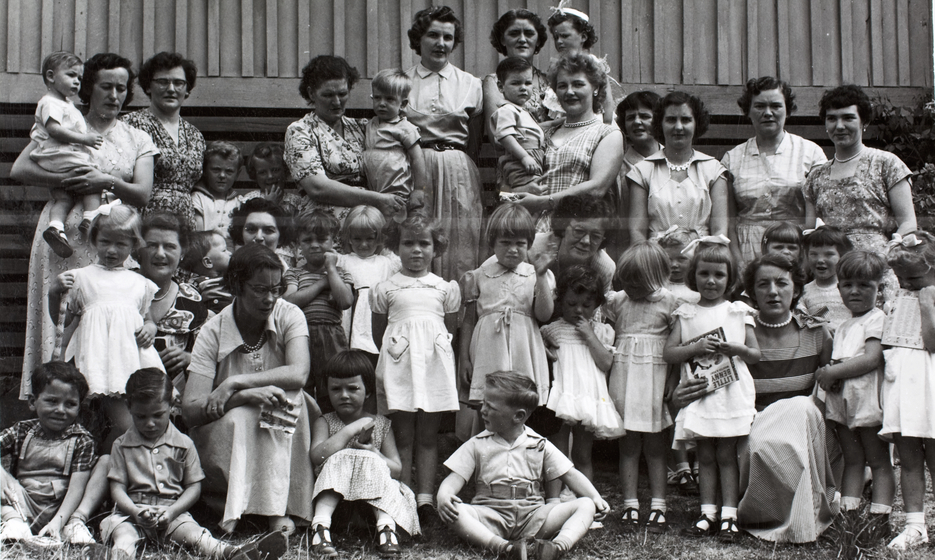 Large group of school children and women