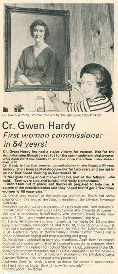 Newspaper article with a woman hanging a framed portrait