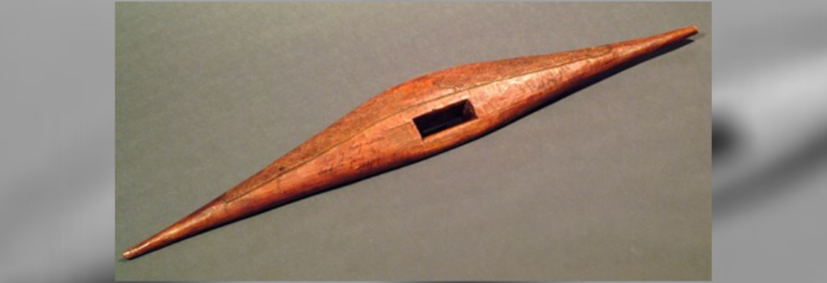  long, shaped wooden shield with rectangular section cut out for placing hands 