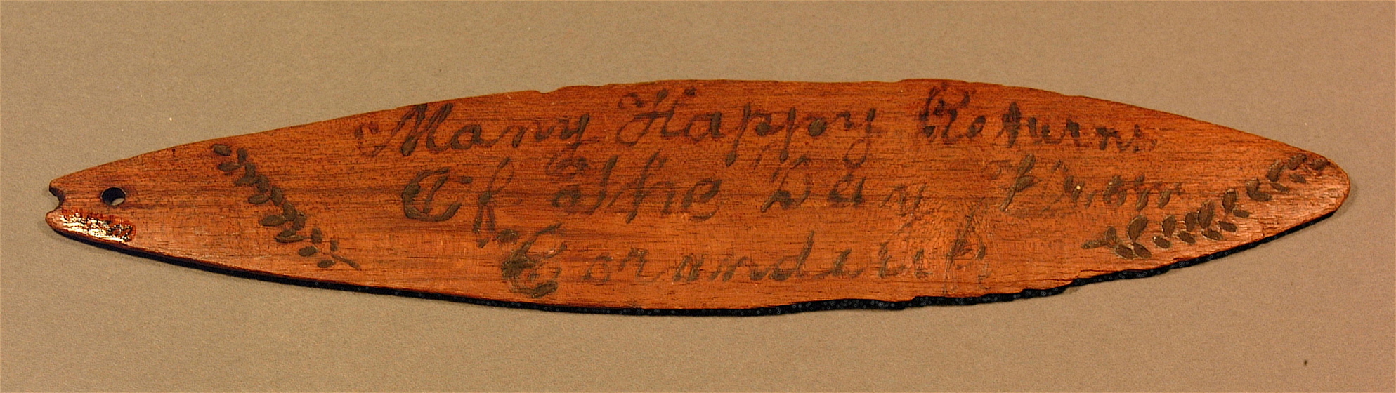 large, flat oval timber with stylised writing