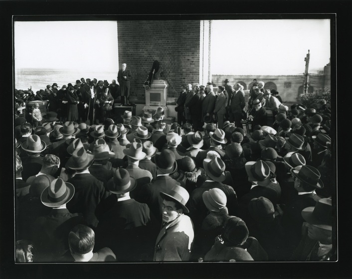 a large crowd of people at the unveiling of a clocktower