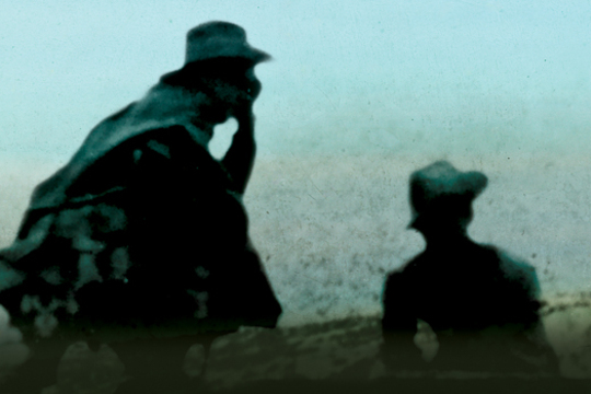 Soldiers kneeling near cross
