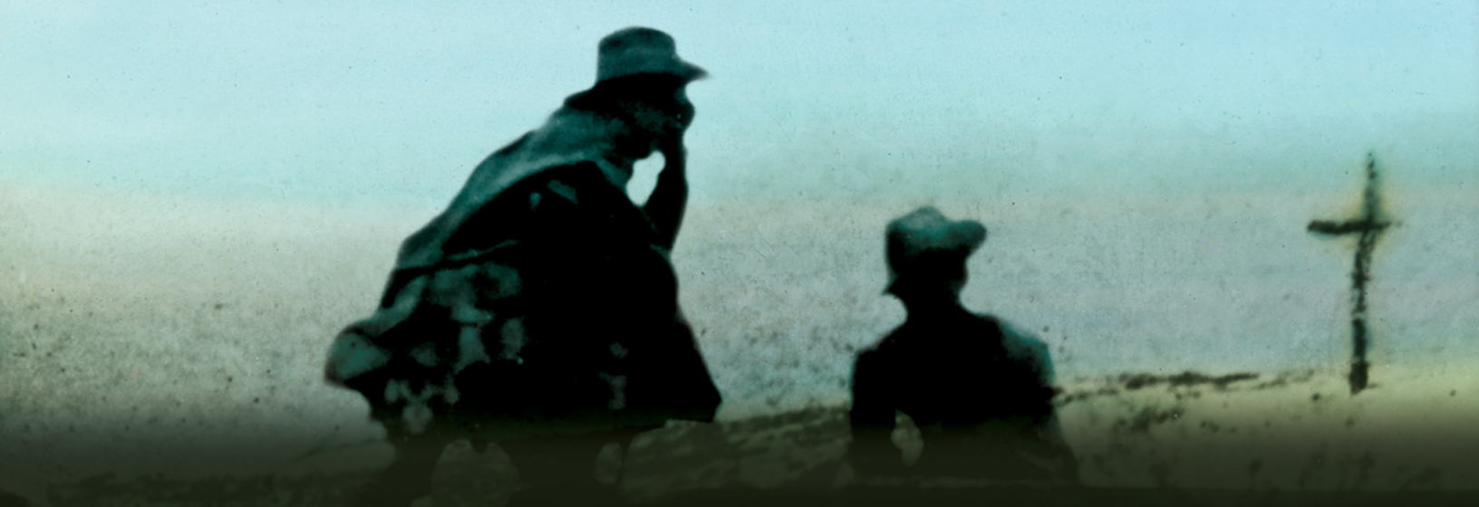 Soldiers kneeling near cross