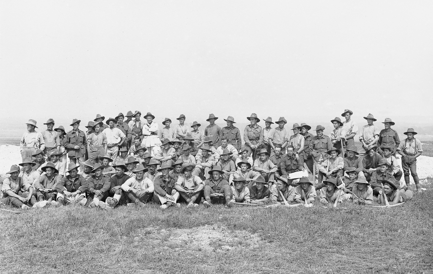 A large group of men seated outdoors
