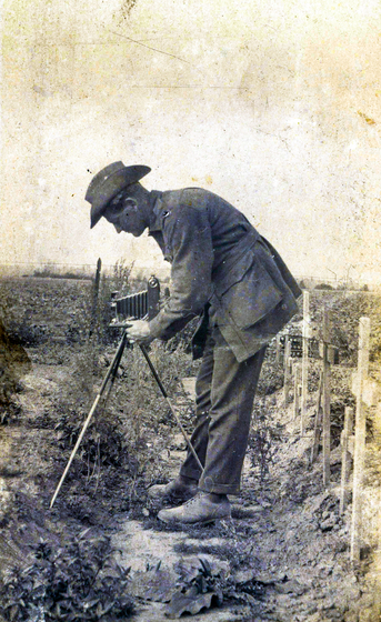 Man with a camera in a cemetery