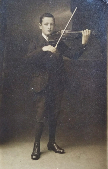 Portrait of a teenage boy playing the violin