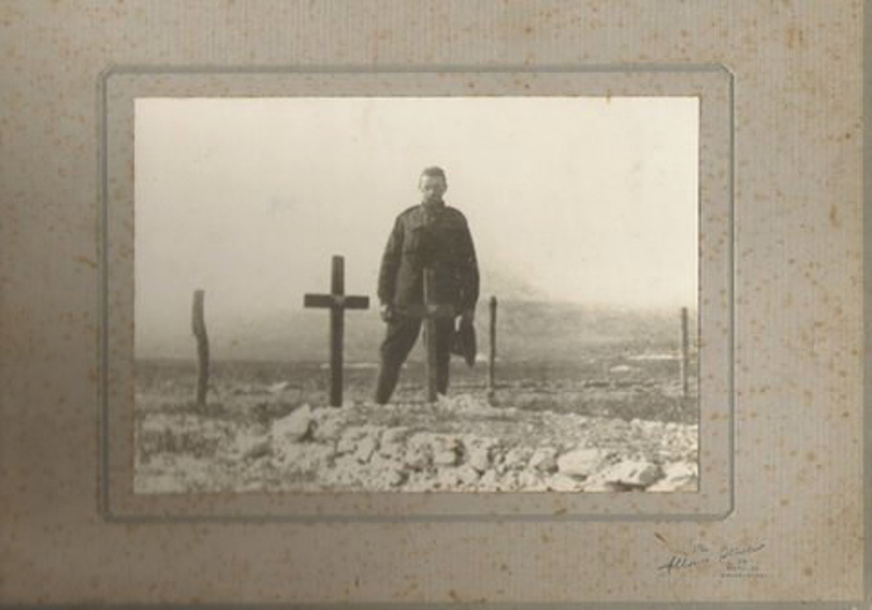 A man standing on a newly dug grave
