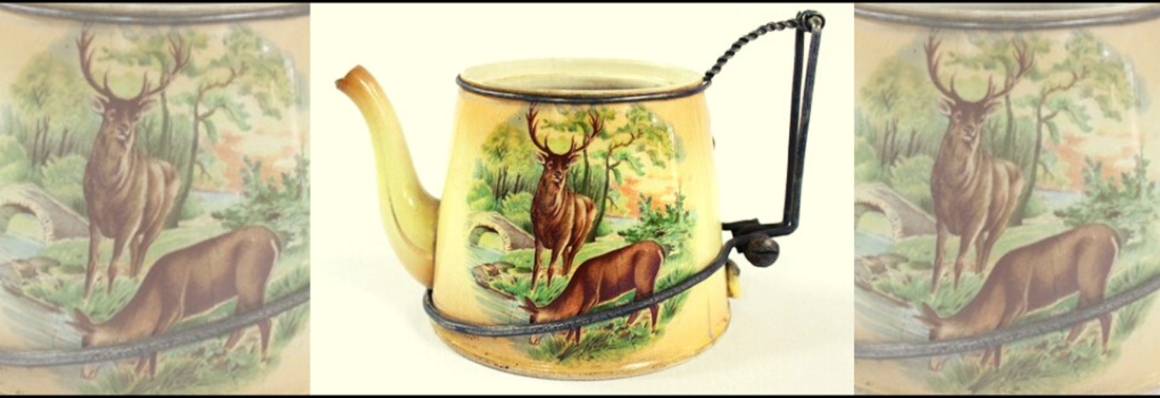 A ceramic teapot with a repaired metal handle. The teapot features a design with a woodland scene with two deer. 