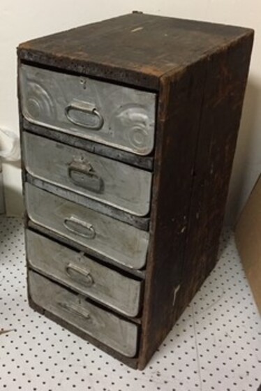 A set of metal and timber drawers made from recycled kerosene tins and box.