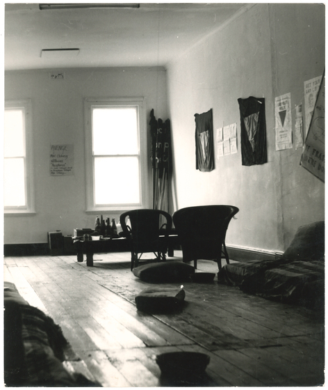 Inside a room with some chairs and posters on the wall.