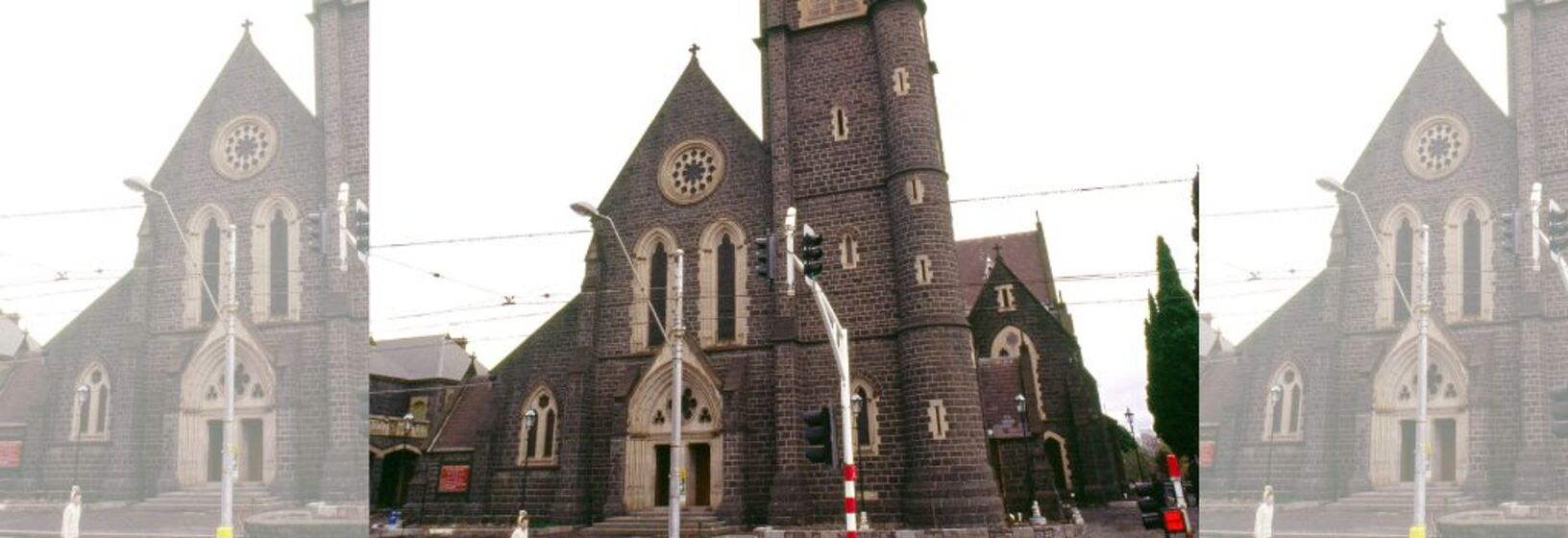 Building facade of brown brick church with steeple/bell tower
