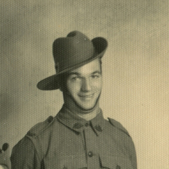 Detail of black and white studio photograph of young man in Australian army uniform.