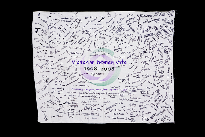 Banner with the Victorian Women Vote 1908 to 2008 logo with signatures hand written over it.