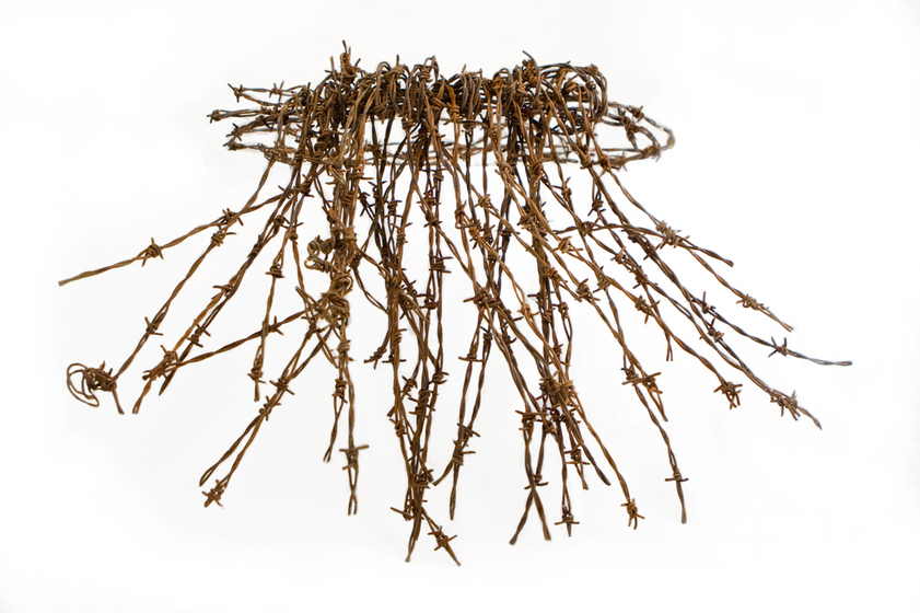 A lap lap made out of a fringe of rusty barbed wire.