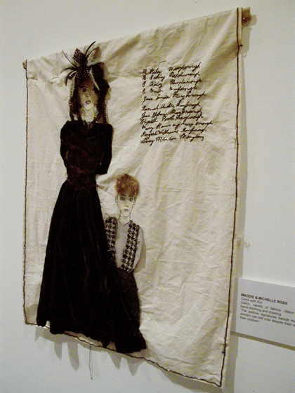 Woman and boy rendered in applique, stitching and drawing on calico.