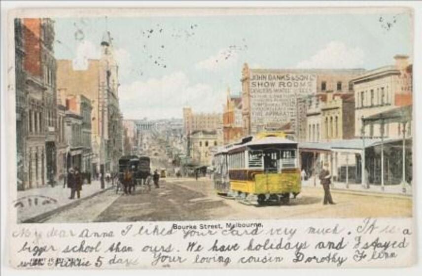 Tinted black and white postcard of a tram in Victorian street. Part of handwritten message on bottom margin.