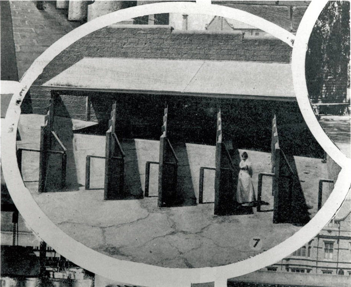 Detail from the page of a black and white journal showing a woman in white standing in a prison yard.