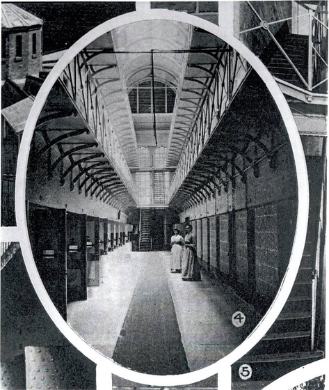 Detail from the page of a black and white journal showing a view along the interior gallery of a Victorian prison. Two women standing on the ground floor.