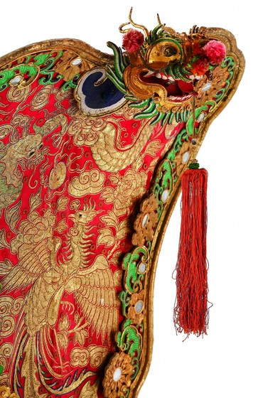 Detail of colourful processional fan with gold embroidery and inlay. 