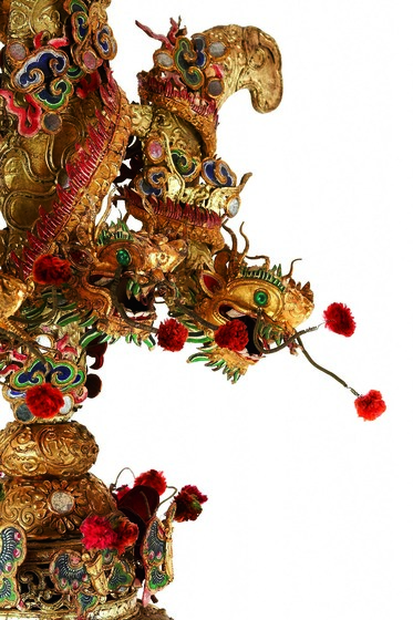 Elaborate gilt and polychrome fleur-de-lis-shaped finial with dragons, butterflies and a fringe.