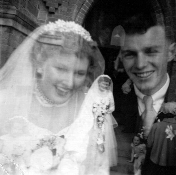 Black and white double-exposed photograph of a bride and groom.