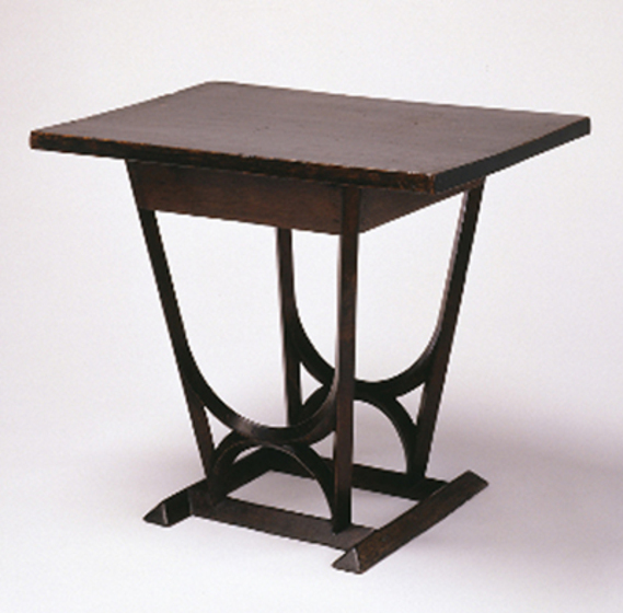 Small black wooden café table with geometric base.