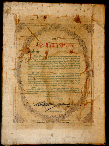 Printed letter in green text addressed to James Harrison Esquire surrounded by a wreath and with a handwritten signature. Paper has many stains.