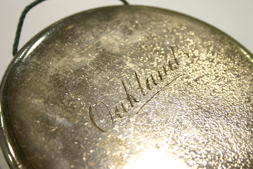 Polished metal gong inscribed, 'Oaklands.'