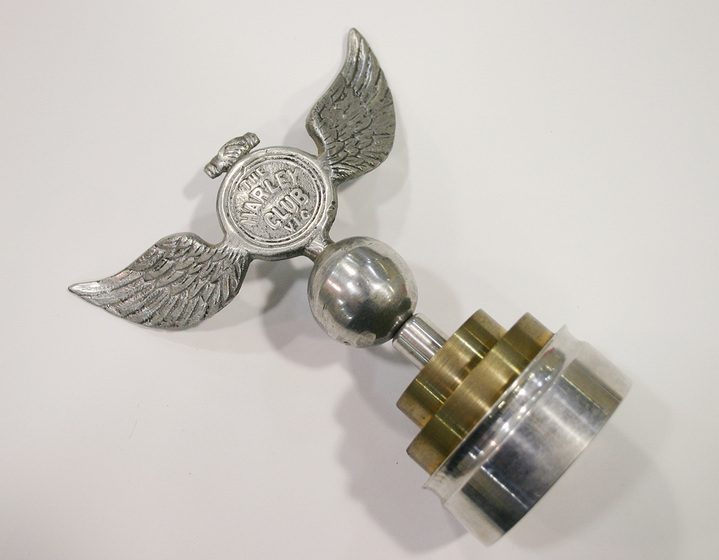 Cast aluminium winged motorbike ornament with the inscription, 'The Harley Club Vic.'