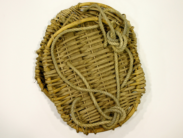 Pair of wicker disks with rope attachments.