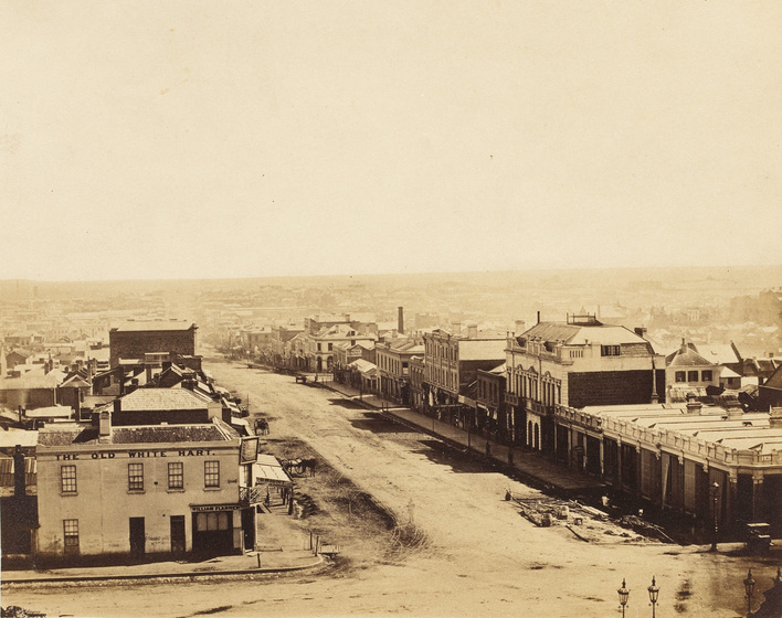 Sepia photograph of an intersection in a colonial Victorian city taken from a high vantage point.