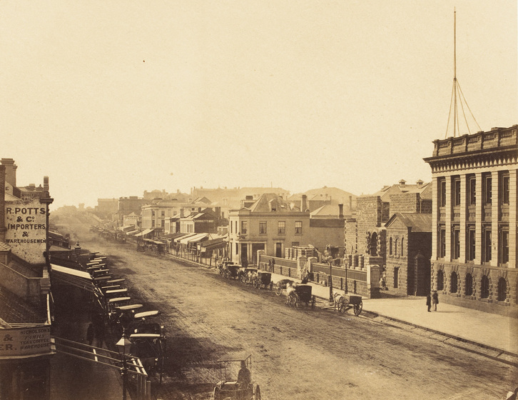 Sepia photograph of a street in a colonial Victorian city.