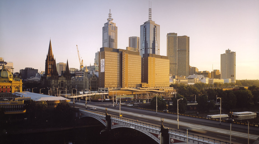 Colour photograph of a city skyline, including a cathedral an a bridge.