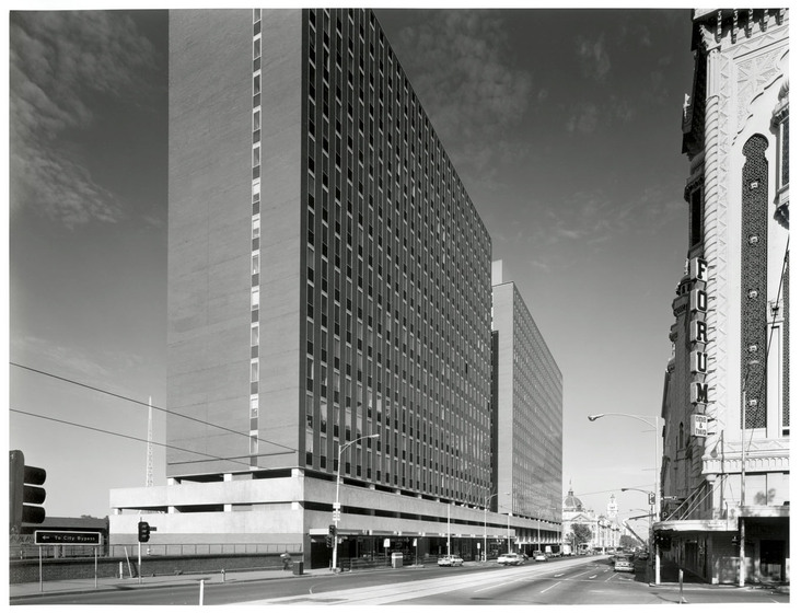 Black and white photograph of two modernist high rise buildings.