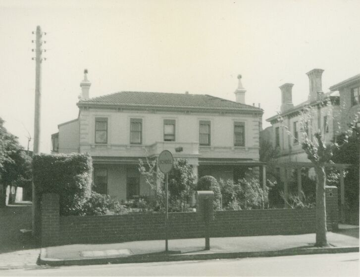 Black and white photograph of a two-storey Victorian mansion with a central portico and quoins.