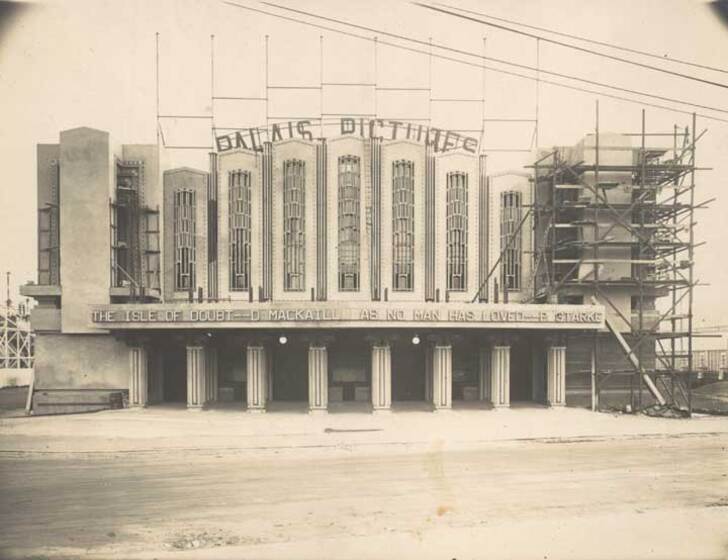 Black and white photograph of an Art Deco façade partially clad with scaffolding and with the sign, 'Palais Pictures'.